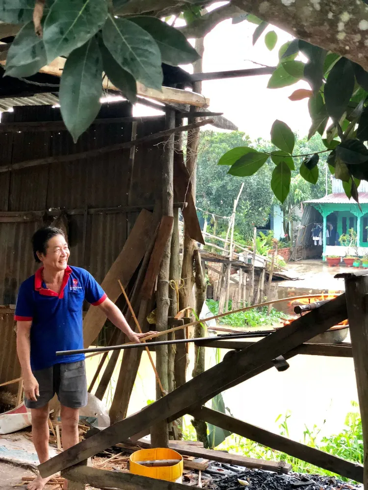 Sampan maker heats wood over a fire in vietnam